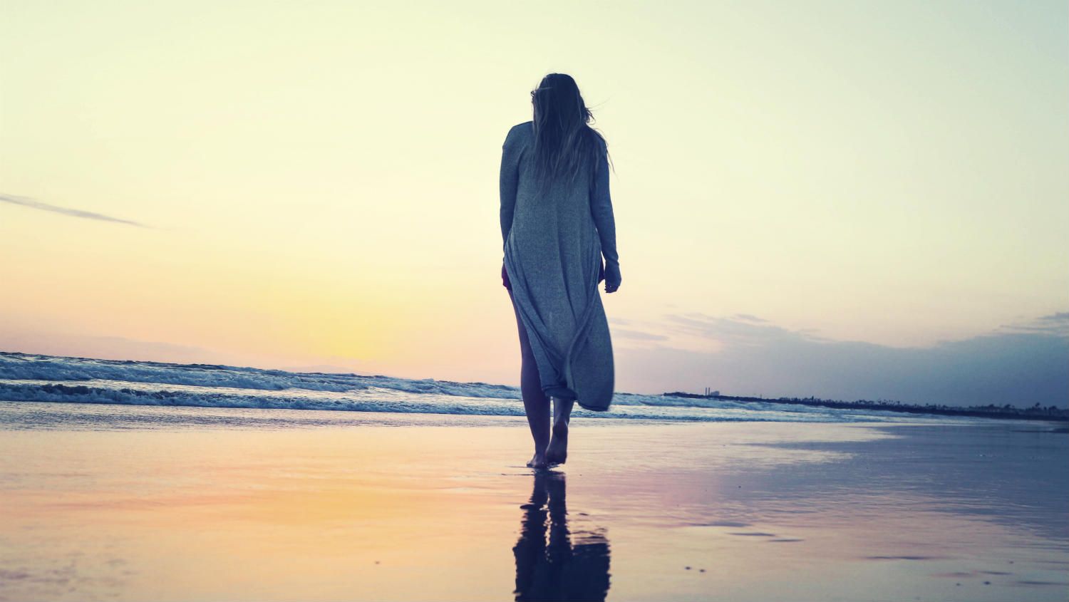 Woman walking alone on a beach